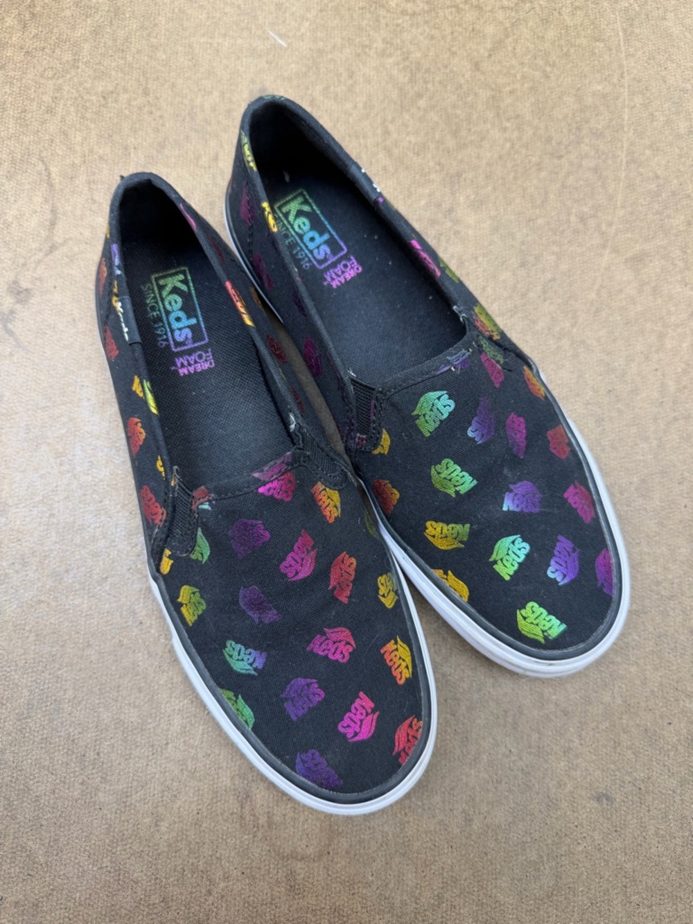Keds Black Slip-On Sneakers with Multicolor Logo Print